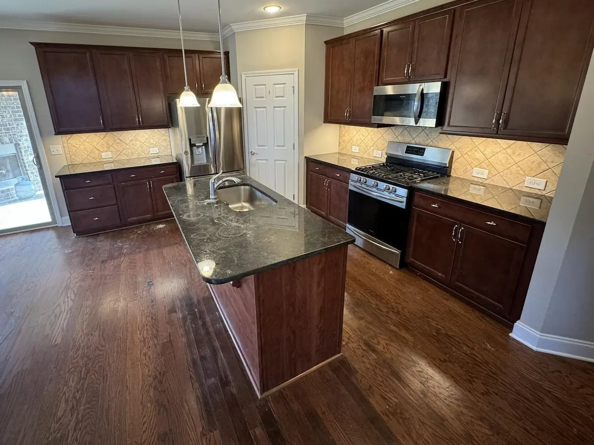 After: the same kitchen following the final clean, floors and surfaces shining